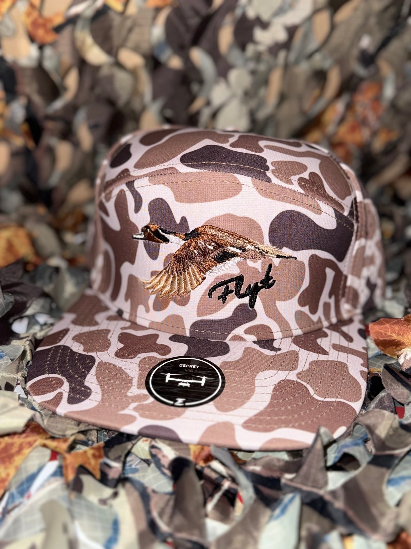 Water resistant camo snap back with pintail.